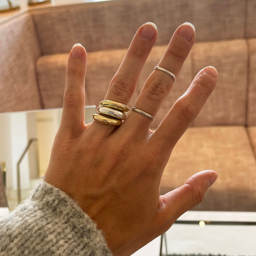 A photo of the cast ring in both 18k gold and sterling silver stacked up to create a beautiful mixed metal look.