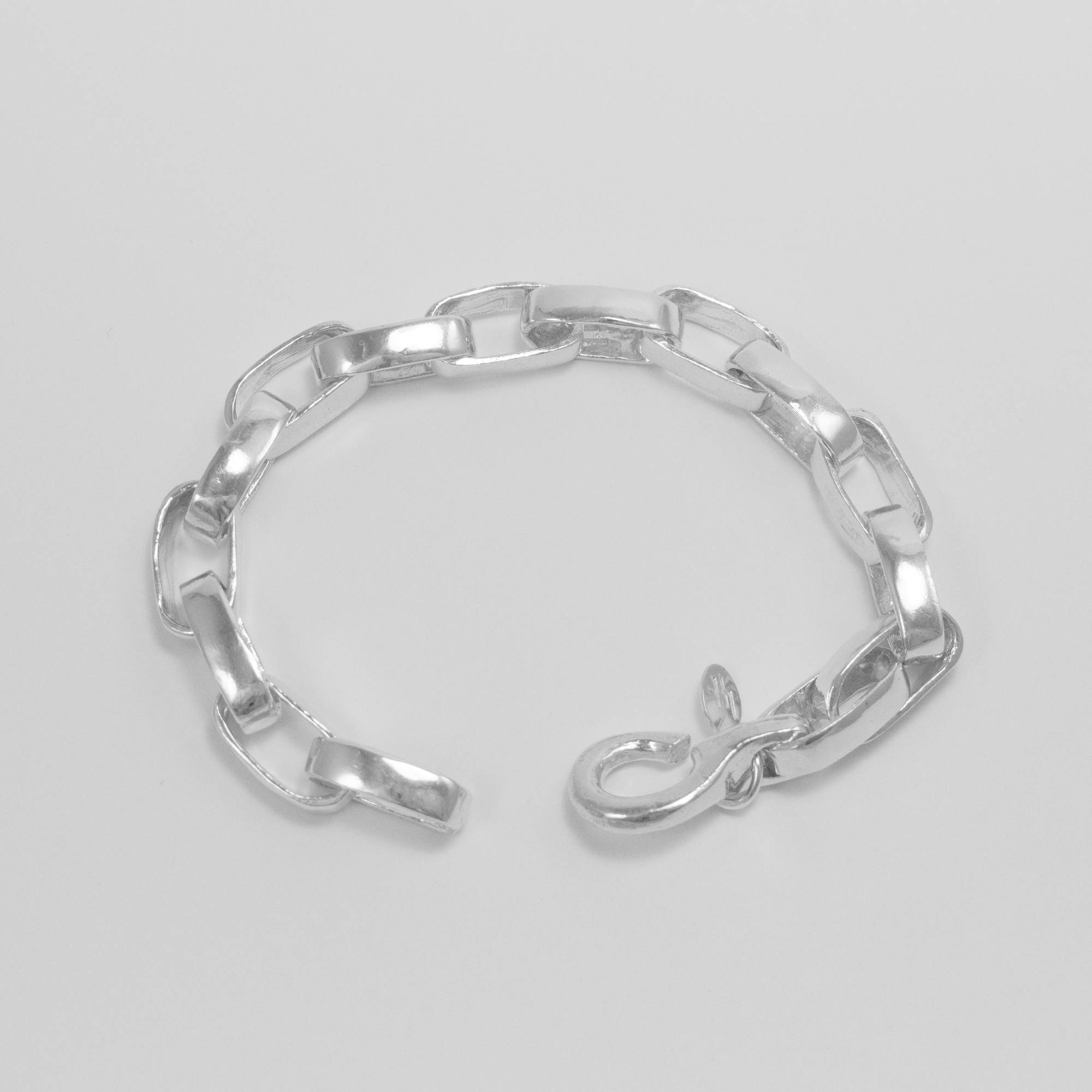 A product shot with minimal background showing the cast links of the Greta Bracelet, as well as the new cast hook clasp.