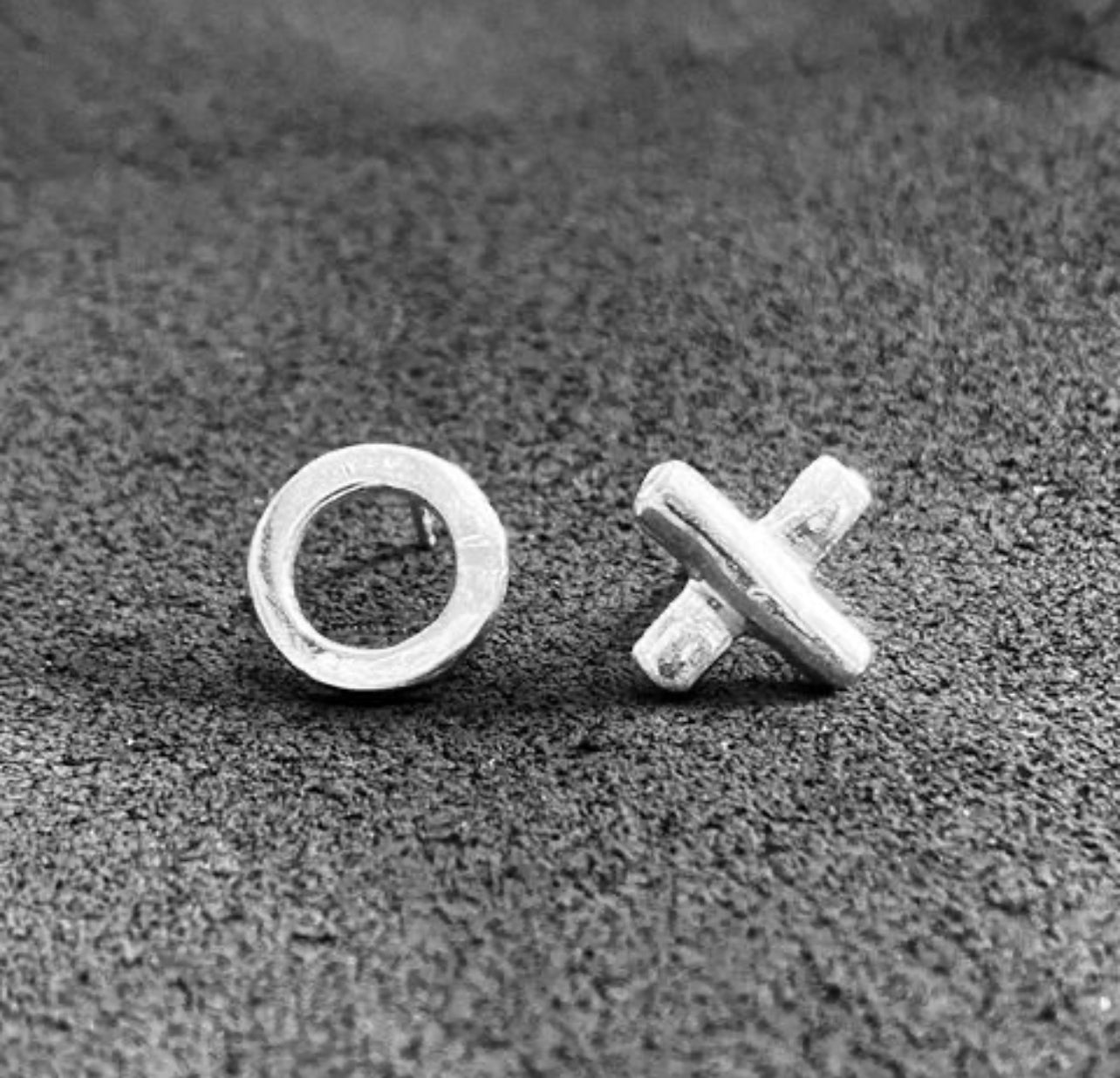 A product shot of the "XO" configuration of the tic-tac-toe earring to show relative size comparison of the two.