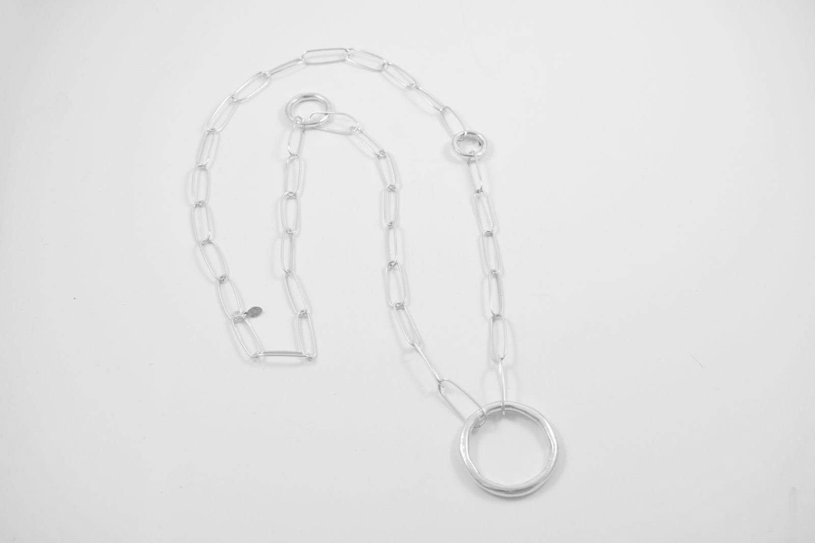 Madeline Necklace lain flat showing a more detailed view of the individual handmade sterling silver links and contrasting solid cast circles.