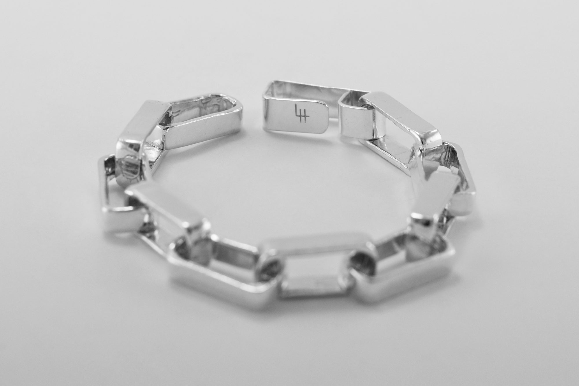 An image of the Theo Bracelet, a Liz Hanson Metalsmith signature statement bracelet made of hand carved sterling silver minimalist links. This bracelet has a decidedly masculine vibe. 