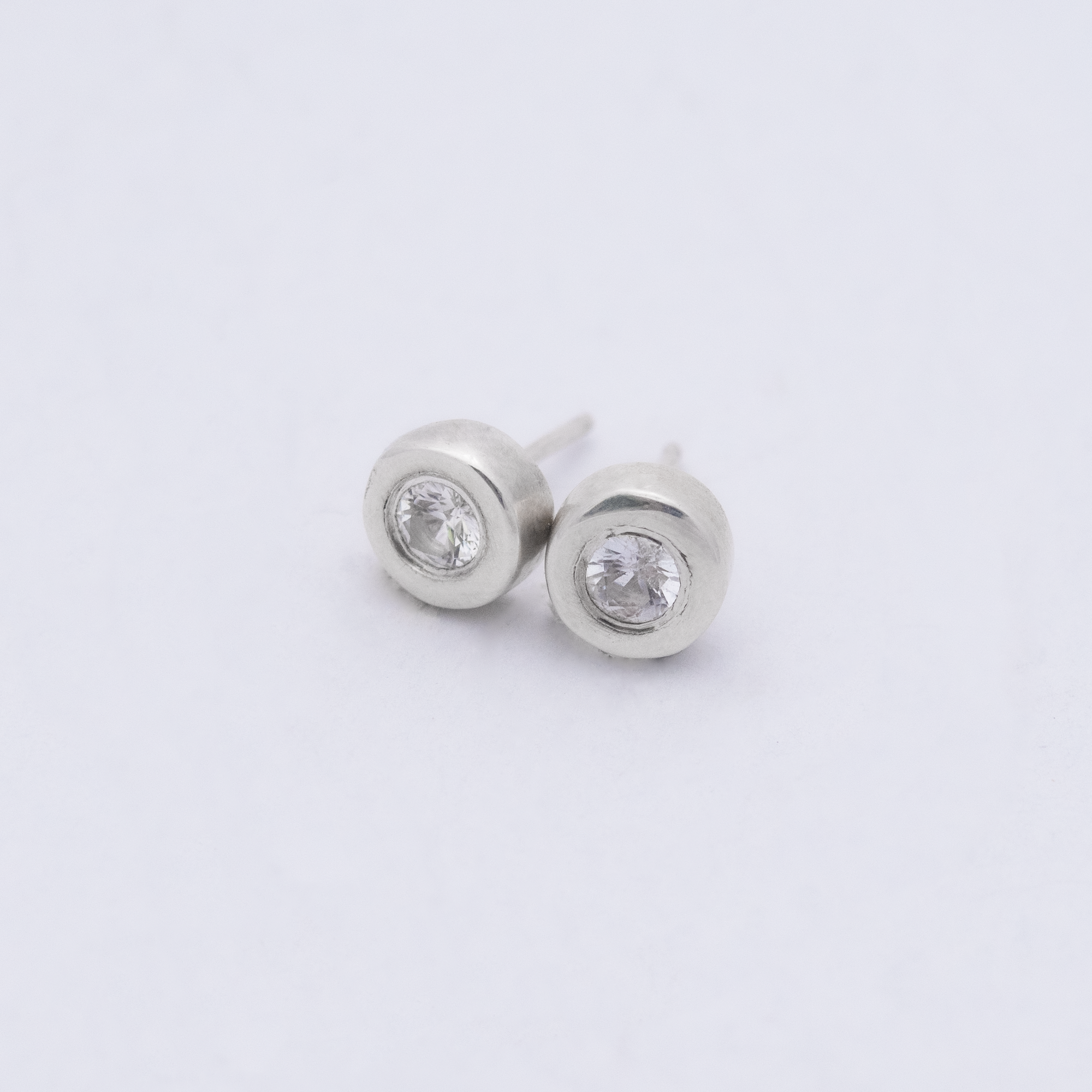4mm white sapphire studs set in a chunky sterling silver, organically shaped setting. the perfect studs!