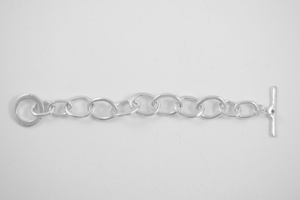 Alanna Bracelet flat lain. Three different link styles make this bracelet an ode to handmade chain.