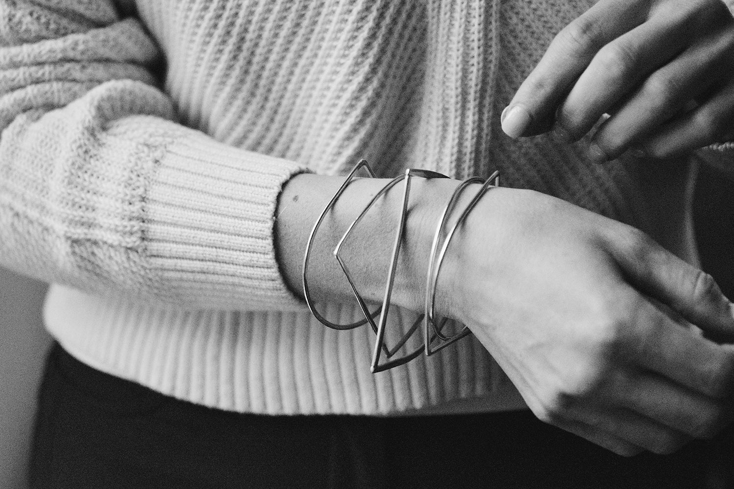 A stack of sterling silve C bar bangles on a model for scale -- these look great worn in a stack or alone.