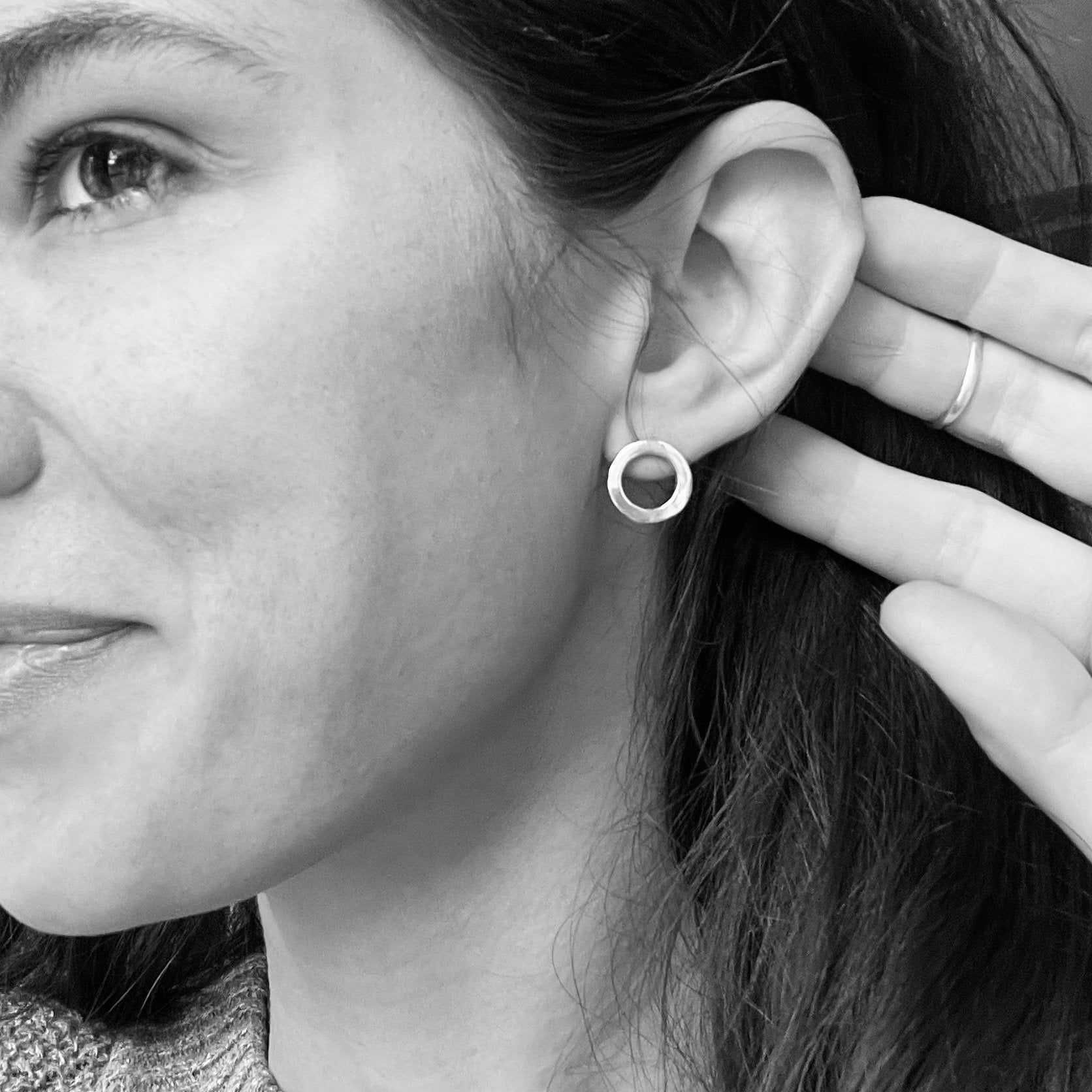 A photo of the cast "O" earring on a model. 
