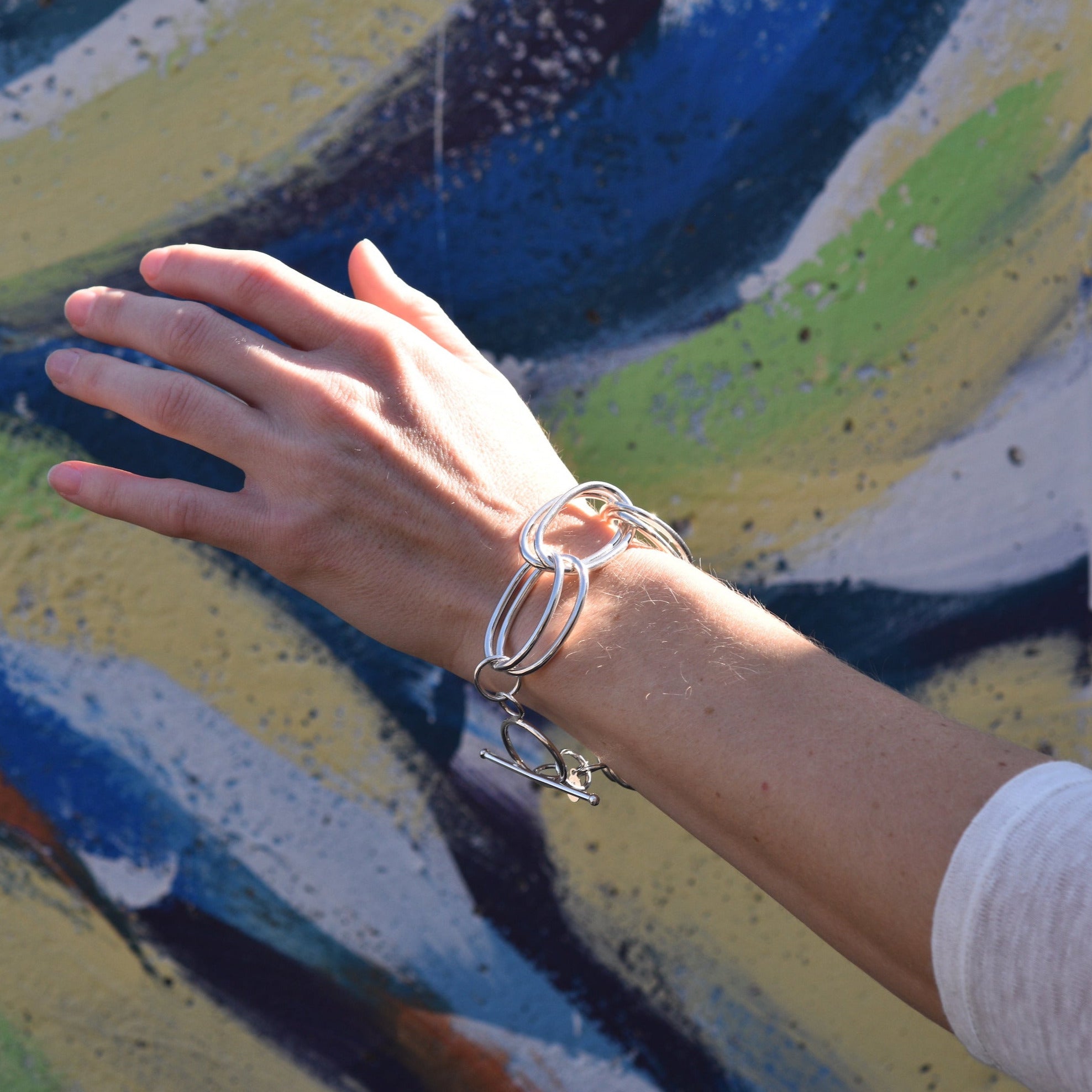 A model wearing the double oval links bracelet, which features hand forged sterling silver links. 