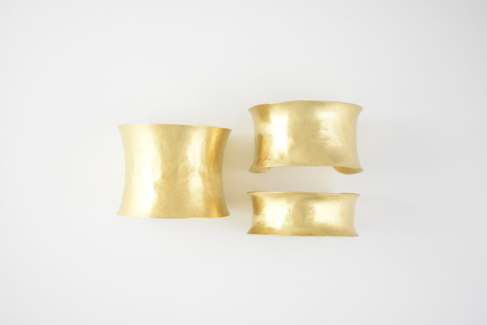 All three sizes of gold-tone, brass hammered cuffs to show relative scale.