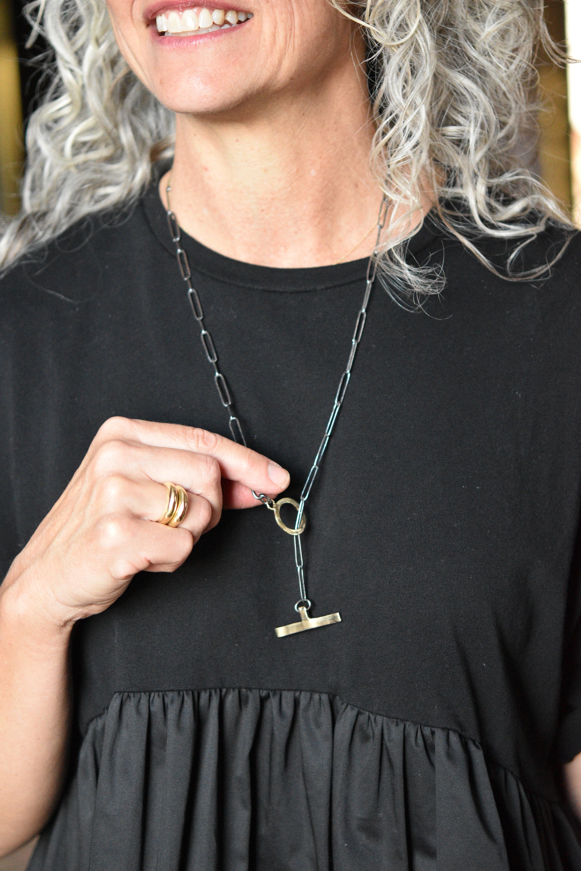 An image of the 14k gold toggle paperclip chain necklace on a model for scale